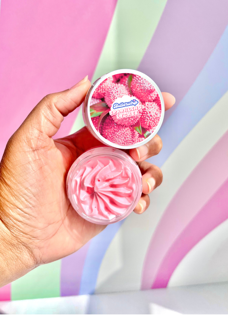 Hand holding 1 oz jar of Sparkling Lychee Body Butter Cream